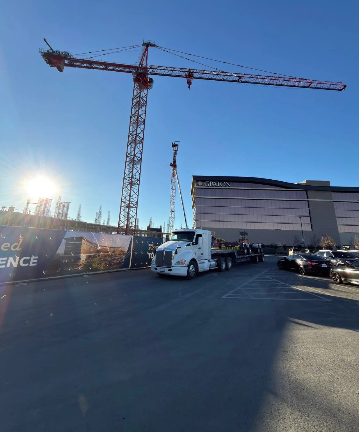 Velazquez Bros truck delivering to a jobsite under a tower crane