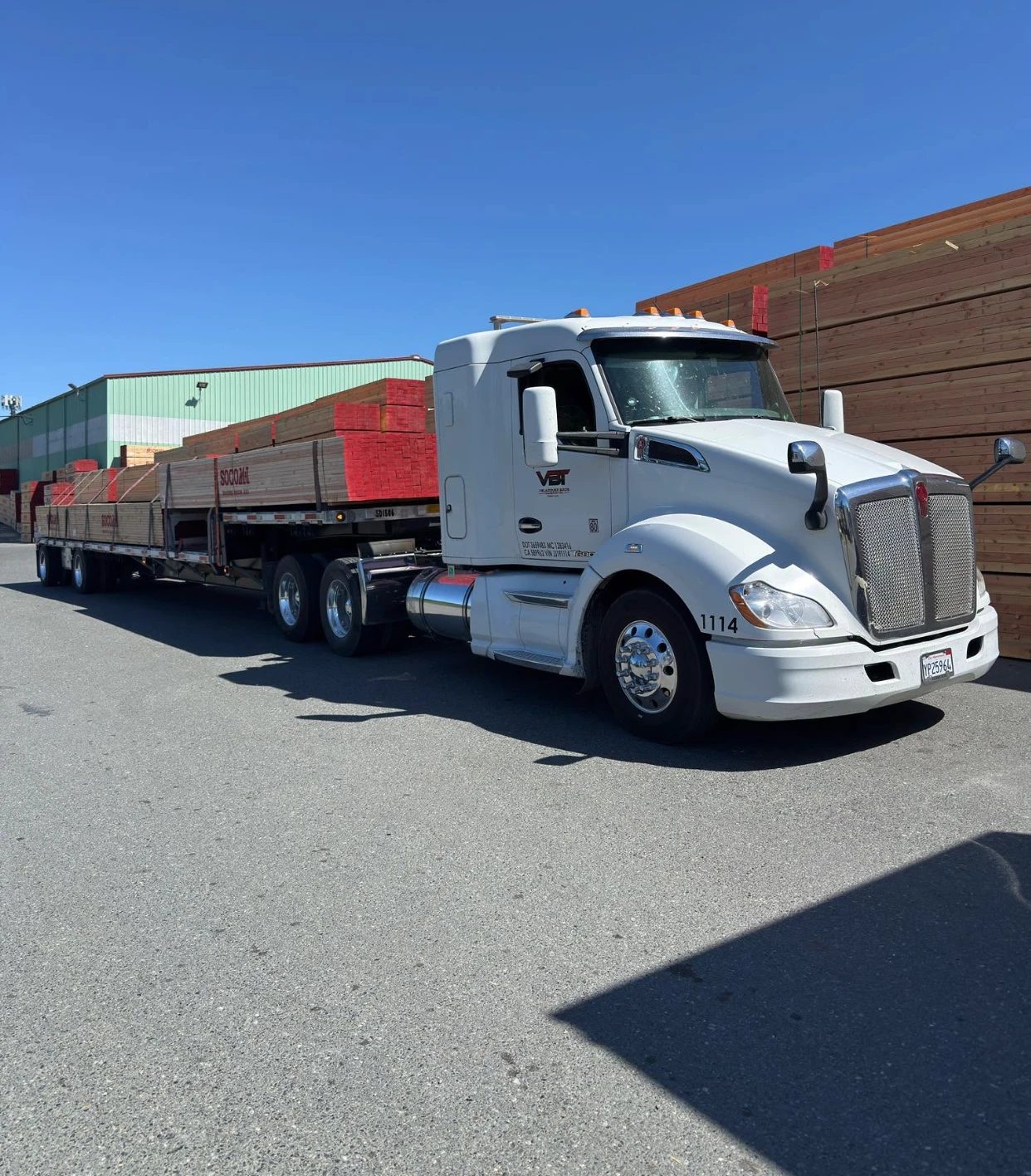 Velazquez Bros flatbed loaded with banded lumber at the mill