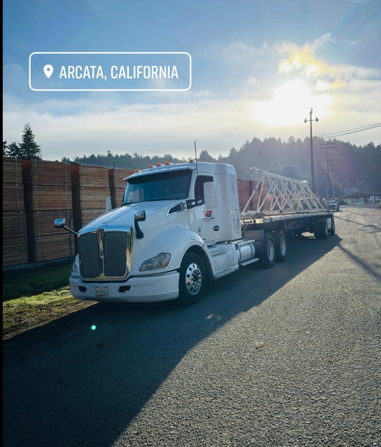 Velazquez Bros truck at sunrise with a crane truss on the deck